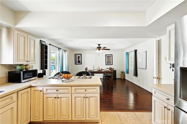 2842 Pietro Dr, Hacienda Heights, CA 91745 - kitchen featuring appliances with stainless steel finishes, a peninsula, ceiling fan, and light countertops