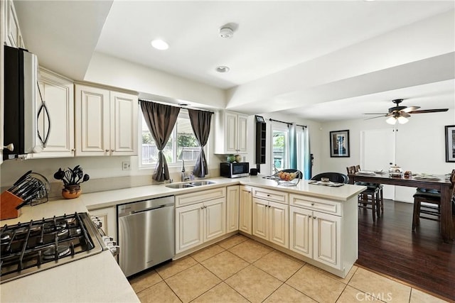 2842 Pietro Dr, Hacienda Heights, CA 91745 - kitchen with appliances with stainless steel finishes, a peninsula, healthy amount of natural light, light countertops, and recessed lighting