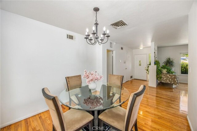 30993 Palo Alto Dr, Redlands, CA 92373 - dining room with a chandelier, light wood-style flooring, and baseboards