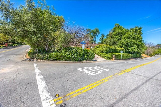 30993 Palo Alto Dr, Redlands, CA 92373 - view of asphalt street featuring traffic signs and curbs