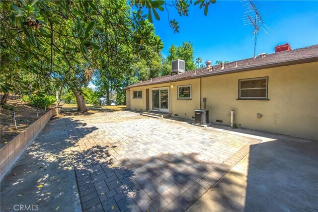 30993 Palo Alto Dr, Redlands, CA 92373 - back of property featuring stucco siding, central air condition unit, and a patio area
