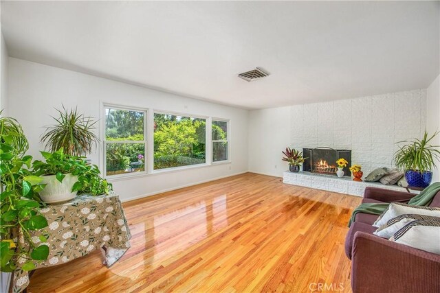 30993 Palo Alto Dr, Redlands, CA 92373 - living area featuring wood finished floors, a brick fireplace, and baseboards