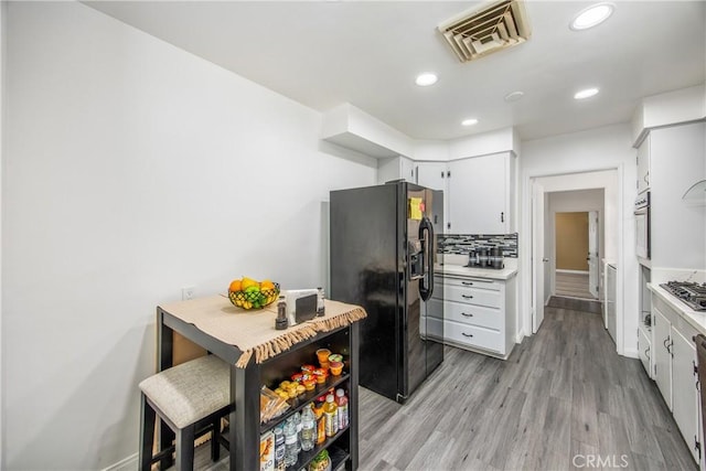 30993 Palo Alto Dr, Redlands, CA 92373 - kitchen featuring stainless steel appliances, light countertops, light wood-style floors, recessed lighting, and white cabinetry
