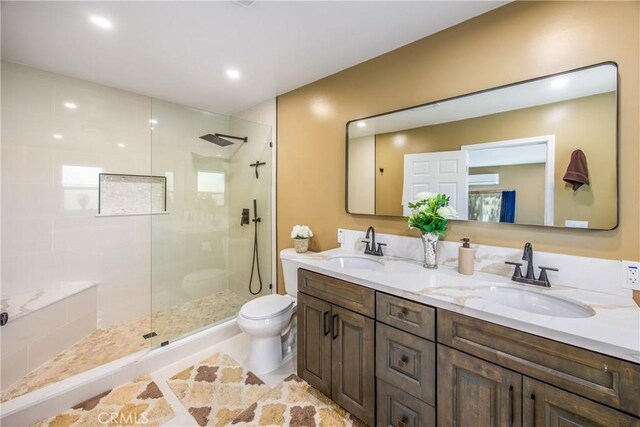 30993 Palo Alto Dr, Redlands, CA 92373 - full bathroom with double vanity, toilet, walk in shower, and recessed lighting