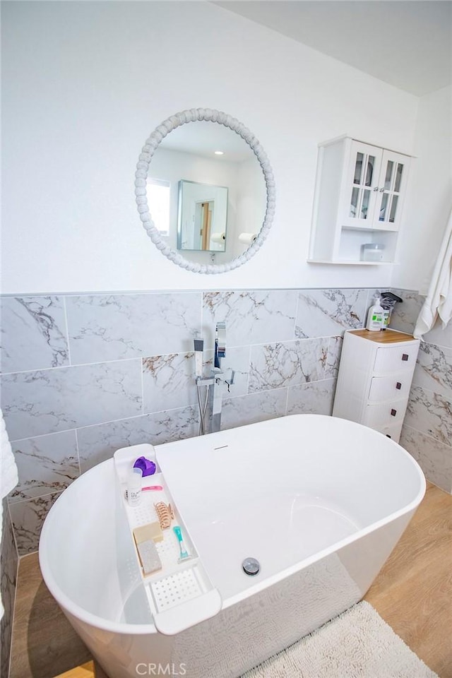 968 Calle Fresa, Nipomo, CA 93444 - full bathroom featuring tile walls, a freestanding tub, a wainscoted wall, and wood finished floors