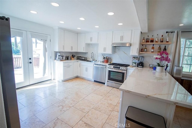 968 Calle Fresa, Nipomo, CA 93444 - kitchen with appliances with stainless steel finishes, a peninsula, open shelves, light stone counters, and white cabinetry