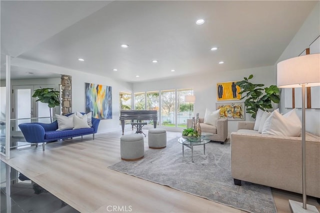 living area with recessed lighting and wood finished floors