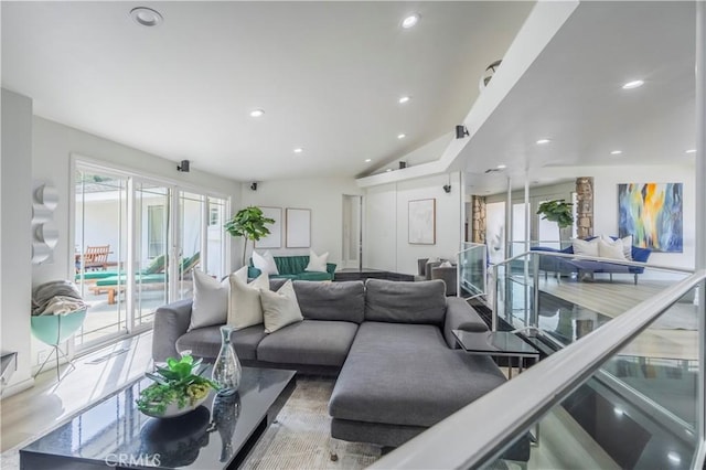 living room featuring recessed lighting and lofted ceiling