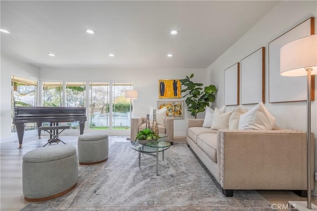 living area featuring wood finished floors, baseboards, and recessed lighting