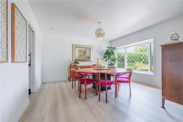 dining area featuring light wood-style floors