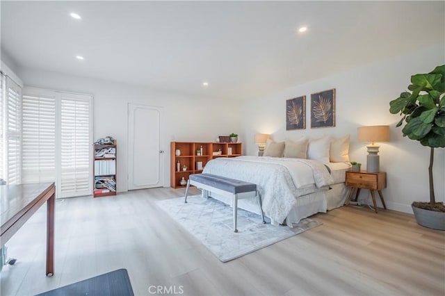 bedroom with baseboards, recessed lighting, and wood finished floors