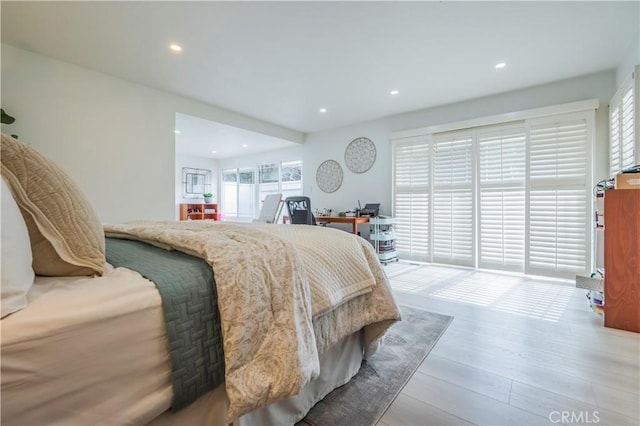 bedroom featuring wood finished floors and recessed lighting