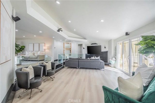 living room with light wood finished floors, vaulted ceiling, and recessed lighting