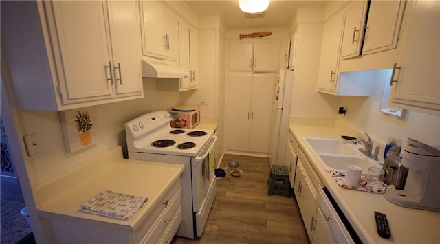 2189 Via Mariposa # C, Laguna Woods, CA 92637 - kitchen with white appliances, under cabinet range hood, a sink, wood finished floors, and white cabinetry