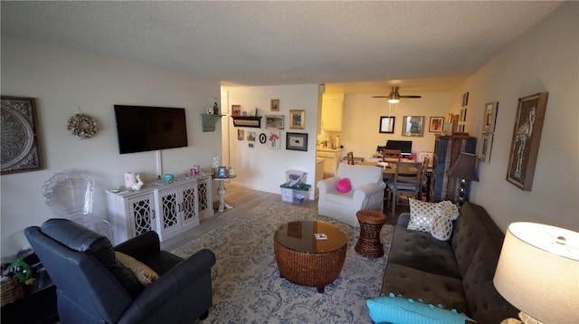 2189 Via Mariposa # C, Laguna Woods, CA 92637 - living area featuring an office area, ceiling fan, wood finished floors, and a textured ceiling