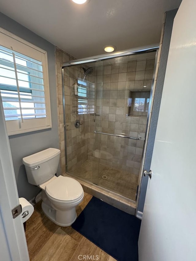 2244 Cannes Sq, Oxnard, CA 93035 - bathroom featuring wood finished floors, toilet, a stall shower, and baseboards