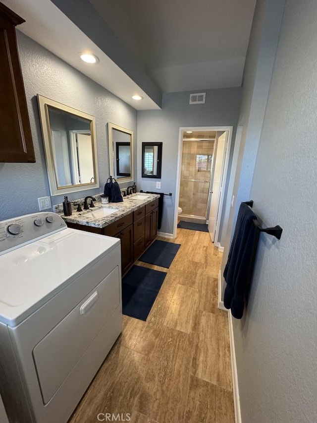 2244 Cannes Sq, Oxnard, CA 93035 - full bath featuring washer / dryer, toilet, wood finished floors, a stall shower, and a textured wall