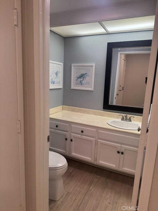 2244 Cannes Sq, Oxnard, CA 93035 - half bathroom featuring vanity, wood finished floors, and toilet