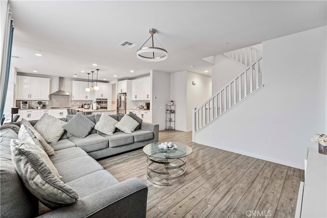 8794 Applewood St, Chino, CA 91708 - living room with visible vents, baseboards, light wood finished floors, recessed lighting, and stairs