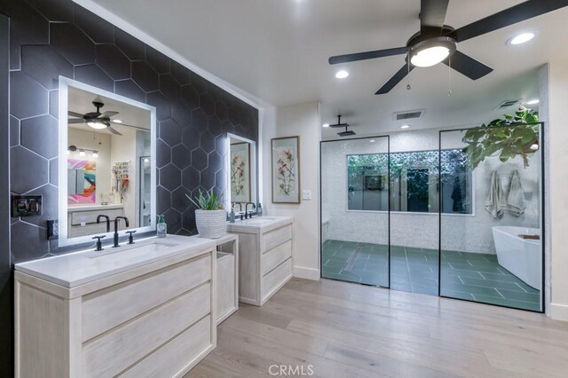 5385 N Van Ness Blvd, Fresno, CA 93711 - bathroom with ceiling fan, a shower stall, wood finished floors, a freestanding tub, and two vanities