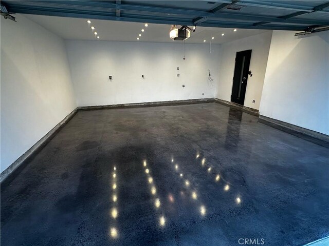 5385 N Van Ness Blvd, Fresno, CA 93711 - garage with a garage door opener and baseboards