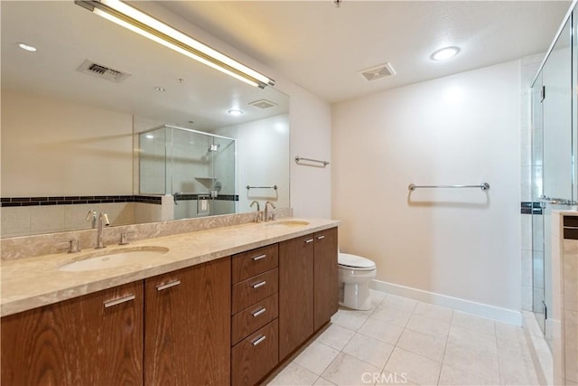 bathroom featuring visible vents, a stall shower, tile patterned flooring, and a sink