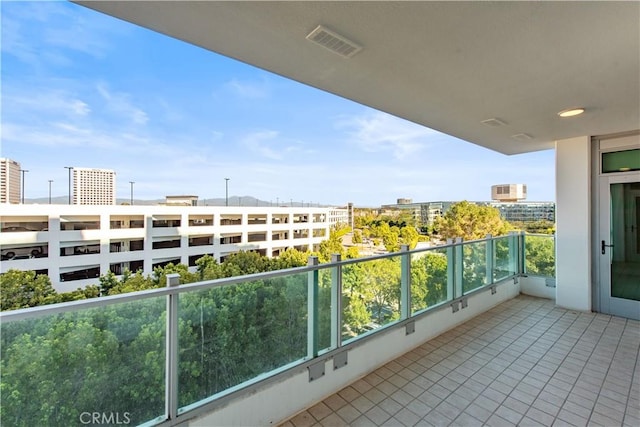 balcony with visible vents and a city view