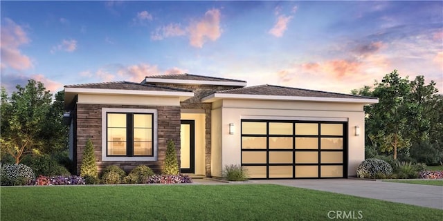 prairie-style house featuring an attached garage, driveway, a front yard, and stucco siding
