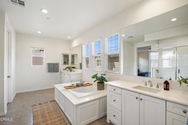 bathroom with a shower stall, tile patterned floors, visible vents, and a sink