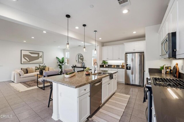 kitchen with visible vents, light tile patterned floors, a sink, recessed lighting, and stainless steel appliances