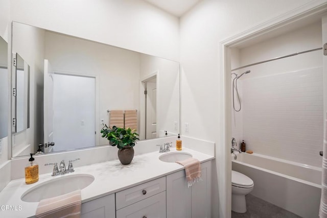 full bath with shower / bath combination, double vanity, a sink, and toilet