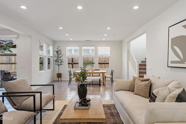 living room with light tile patterned floors, stairs, baseboards, and recessed lighting