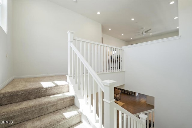 staircase featuring carpet floors, a ceiling fan, and recessed lighting