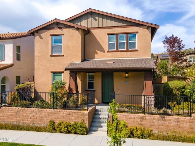 view of front of property featuring a porch, stucco siding, and fence