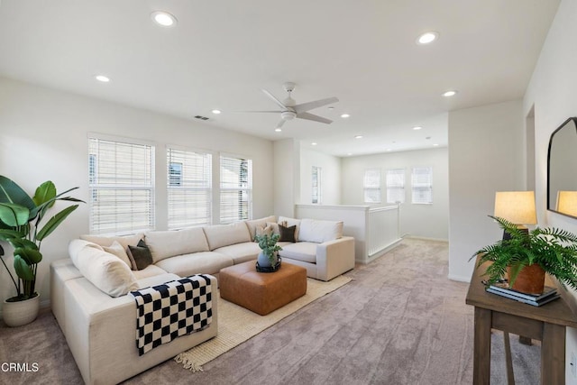 living room with baseboards, a ceiling fan, visible vents, and recessed lighting