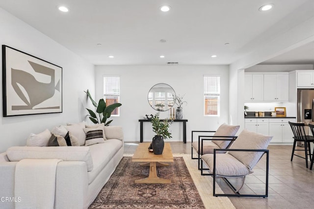 living area featuring visible vents, recessed lighting, and light tile patterned flooring