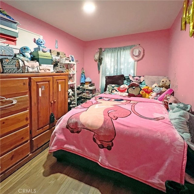 bedroom featuring wood finished floors
