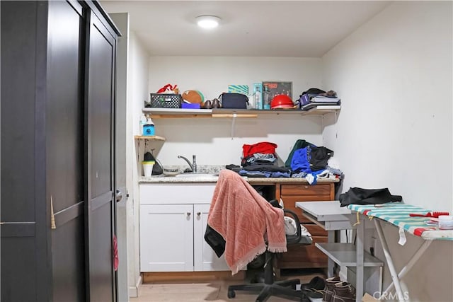 office area with a sink and wood finished floors
