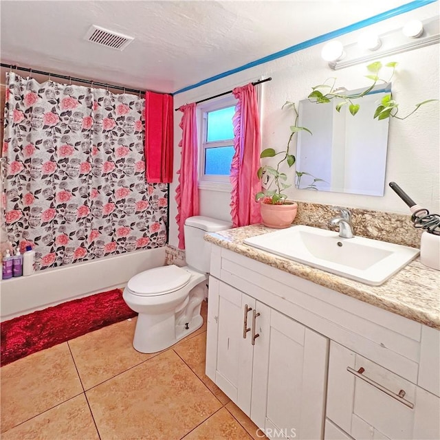 bathroom featuring vanity, tile patterned flooring, visible vents, toilet, and shower / bath combo