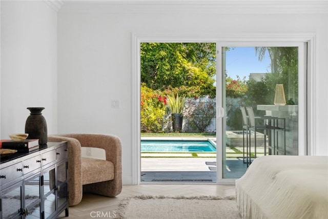 doorway to outside featuring ornamental molding and plenty of natural light