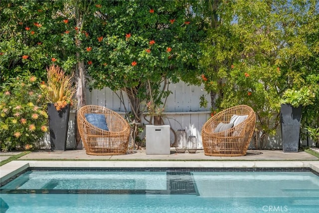 view of swimming pool featuring a fenced in pool