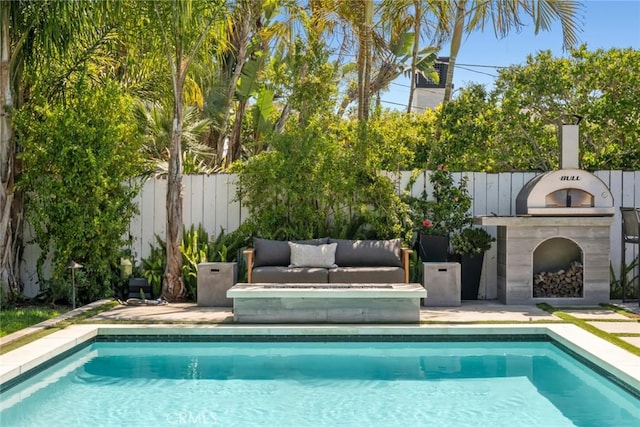 view of swimming pool featuring fence, a patio, and a fenced in pool