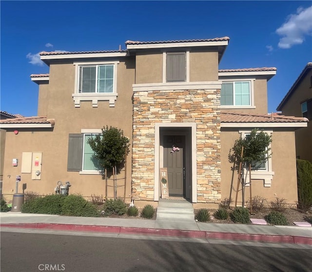 159 Linden Ct, Perris, CA 92571 - view of front facade with stucco siding, a tiled roof, and stone siding