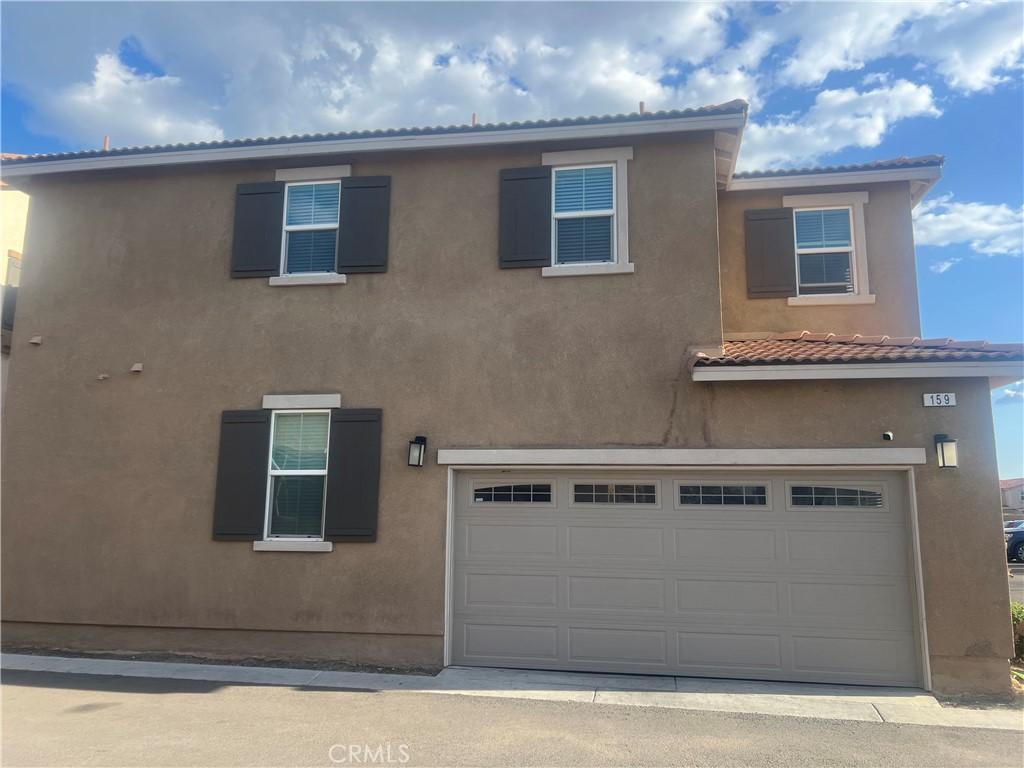159 Linden Ct, Perris, CA 92571 - view of front of property with a tile roof, an attached garage, and stucco siding