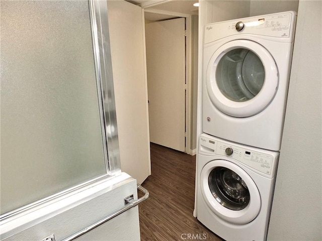 laundry room with laundry area, stacked washer / dryer, and dark wood-style floors
