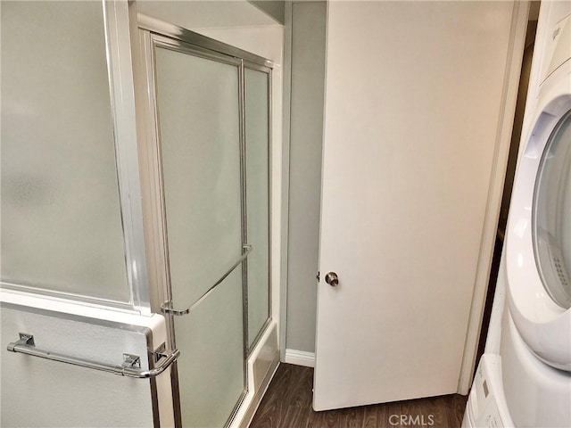 bathroom featuring washer / dryer, wood finished floors, and baseboards