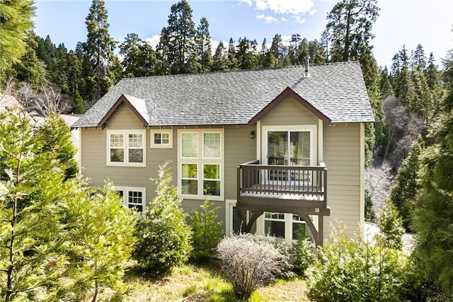 back of property featuring a shingled roof