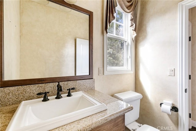 bathroom featuring vanity and toilet