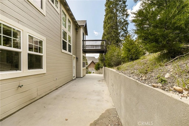 view of side of property with a patio area