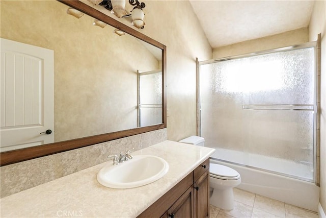 bathroom with shower / bath combination with glass door, tile patterned flooring, vanity, and toilet